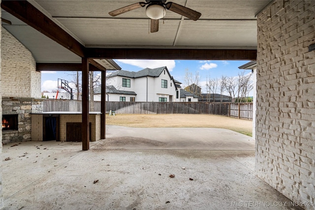 view of patio / terrace with an outdoor stone fireplace and ceiling fan