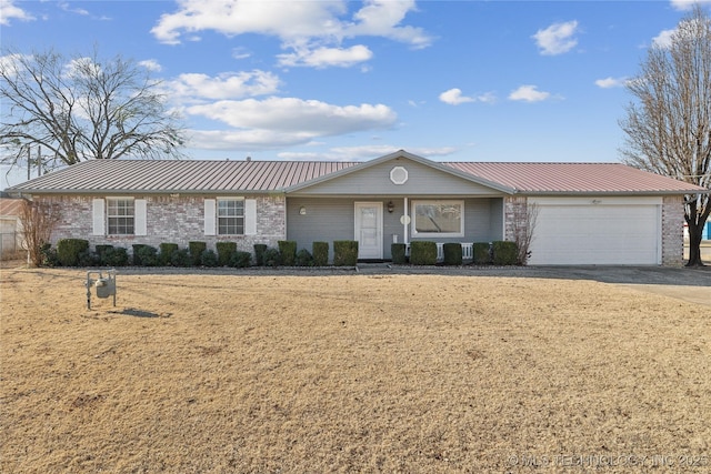 ranch-style home featuring a garage and a front lawn