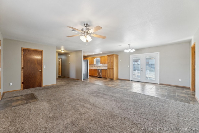 unfurnished living room with french doors, ceiling fan with notable chandelier, and light carpet