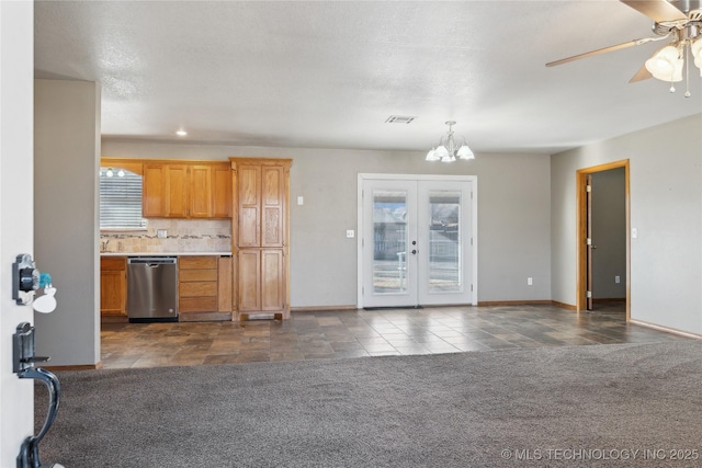 kitchen featuring decorative light fixtures, backsplash, dark colored carpet, stainless steel dishwasher, and french doors