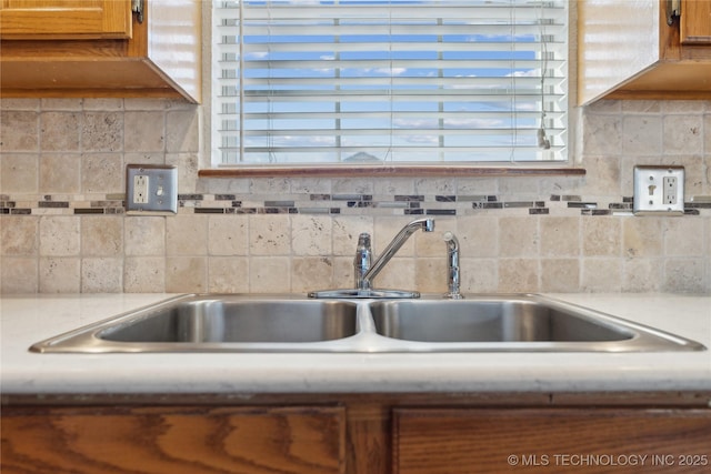 kitchen with tasteful backsplash, sink, and a wealth of natural light