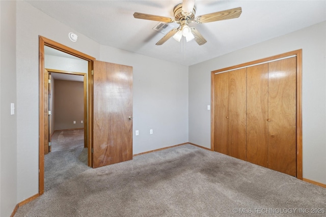 unfurnished bedroom featuring ceiling fan, carpet, and a closet