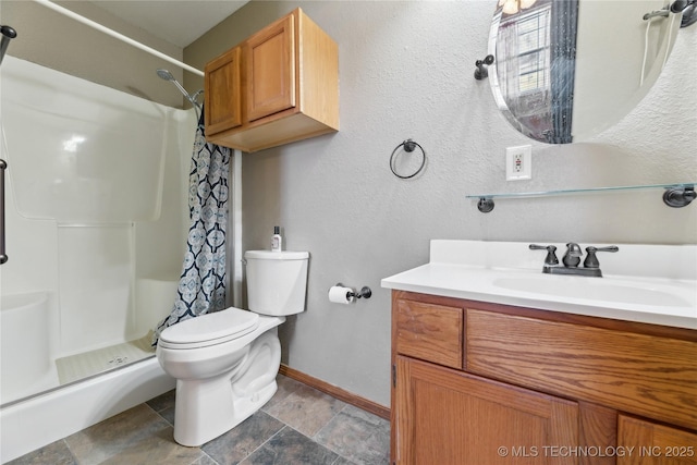 bathroom with vanity, walk in shower, and toilet