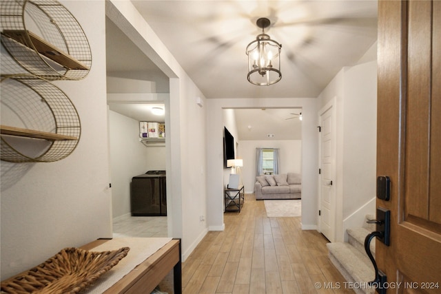 foyer entrance with a notable chandelier and light hardwood / wood-style flooring