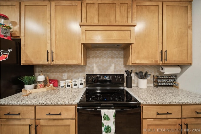 kitchen featuring electric range, light stone countertops, and tasteful backsplash