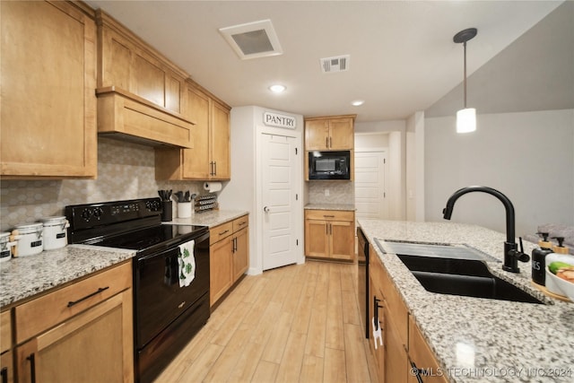 kitchen featuring black appliances, sink, tasteful backsplash, decorative light fixtures, and light stone counters