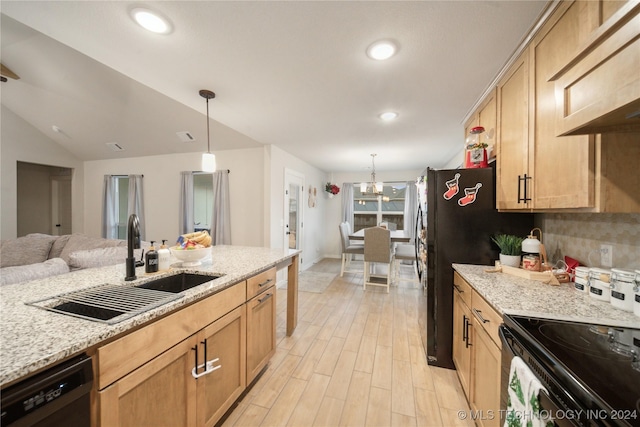 kitchen with light stone countertops, dishwasher, hanging light fixtures, and sink