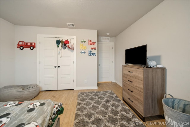 bedroom with a closet and hardwood / wood-style flooring