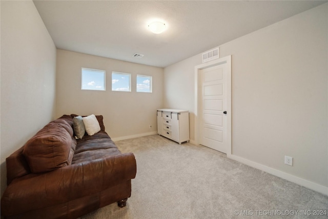 sitting room featuring light carpet