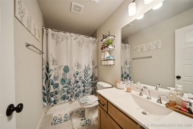 bathroom with tile patterned flooring, vanity, and toilet