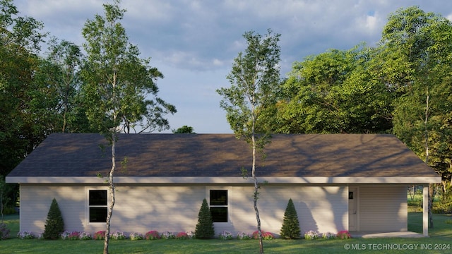 view of side of home with a yard