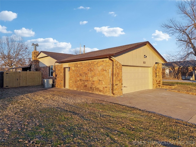 view of home's exterior featuring cooling unit and a garage