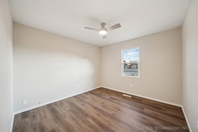 unfurnished room with ceiling fan and dark hardwood / wood-style flooring