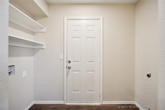 clothes washing area with electric dryer hookup and dark hardwood / wood-style floors