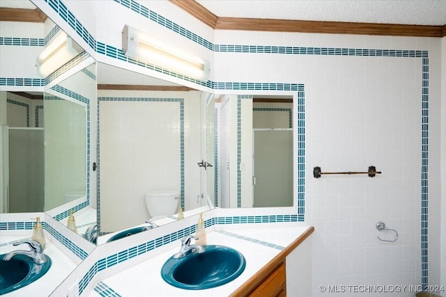 bathroom with vanity, toilet, and ornamental molding