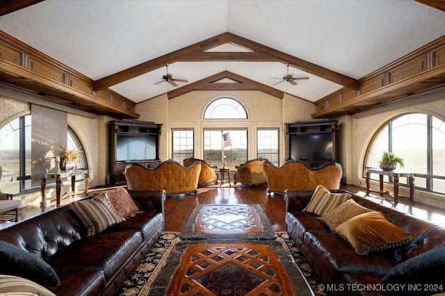 living room featuring vaulted ceiling with beams, hardwood / wood-style flooring, ceiling fan, and brick wall