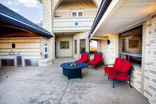 view of patio / terrace featuring an outdoor fire pit