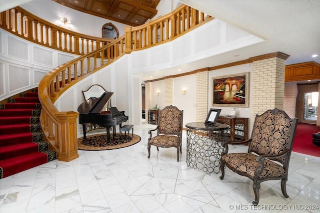 interior space with a high ceiling and crown molding