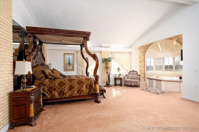 carpeted bedroom with a textured ceiling and vaulted ceiling