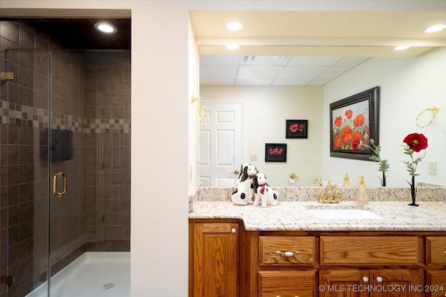 bathroom featuring vanity and an enclosed shower