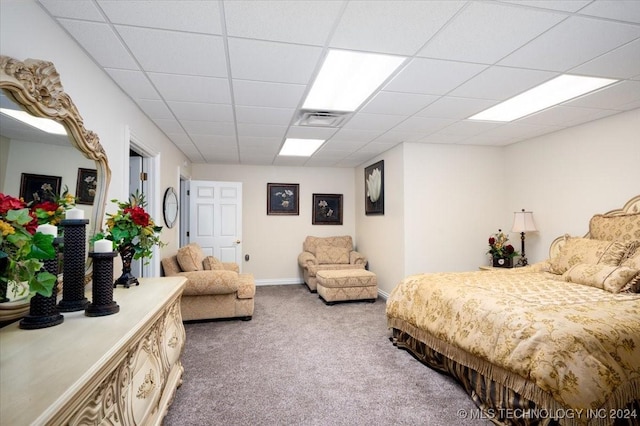 bedroom featuring carpet flooring and a paneled ceiling