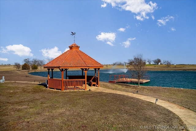 surrounding community featuring a gazebo, a yard, and a water view