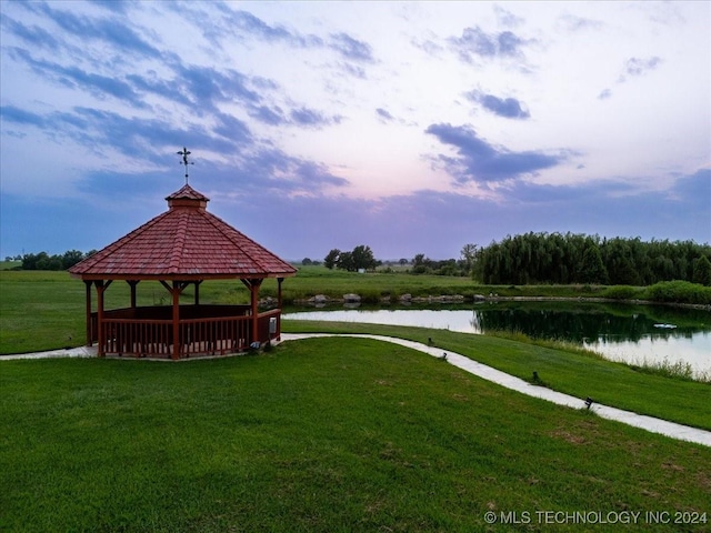 view of community with a gazebo, a lawn, and a water view