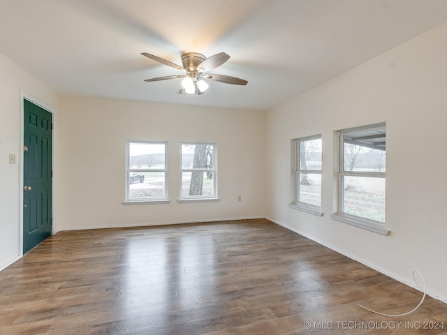 unfurnished room with plenty of natural light, ceiling fan, and wood-type flooring