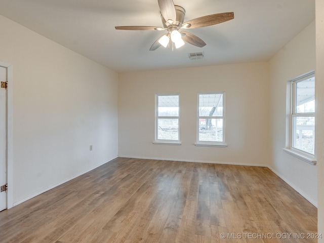 empty room with ceiling fan and light hardwood / wood-style floors