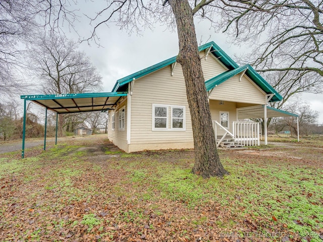 rear view of property featuring a carport