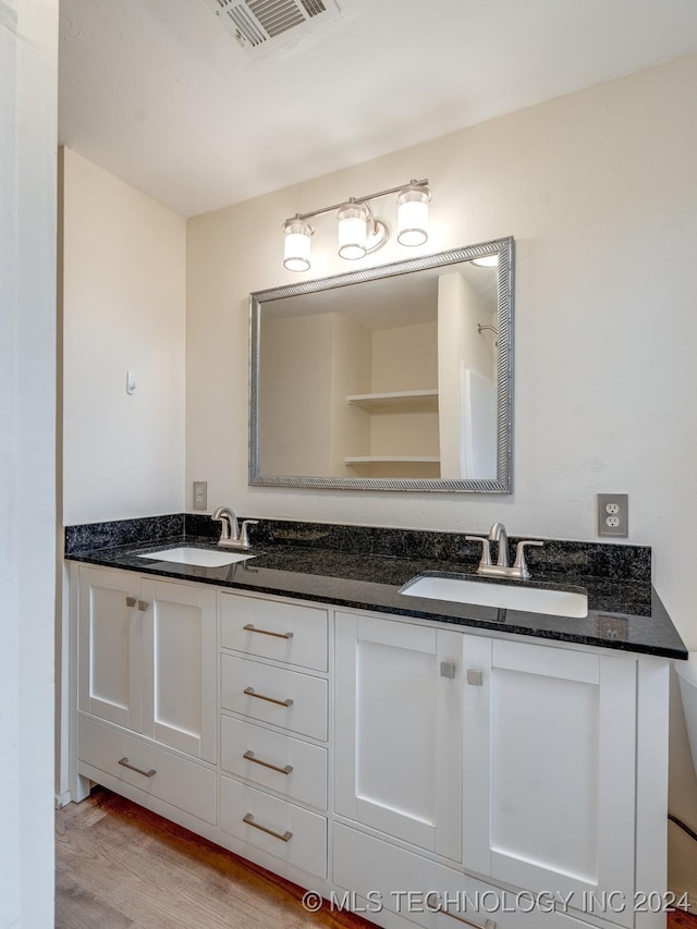 bathroom with hardwood / wood-style floors and vanity