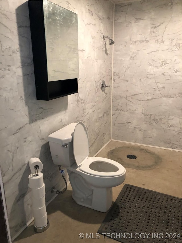 bathroom featuring toilet and walk in shower