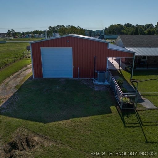 exterior space featuring a lawn and central AC