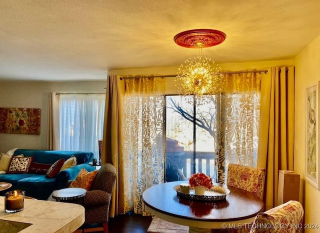 dining room with a textured ceiling and a chandelier