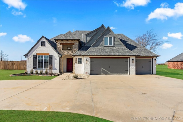 view of front of home featuring a front yard and a garage