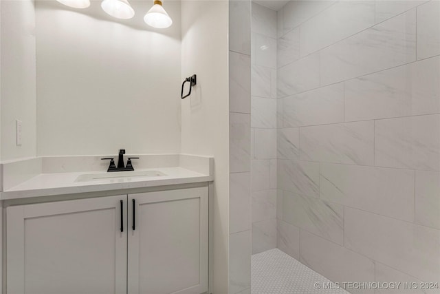 bathroom with vanity and a tile shower