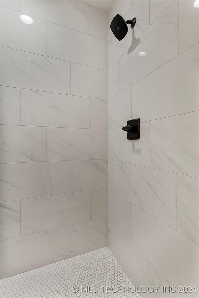 bathroom with tiled shower