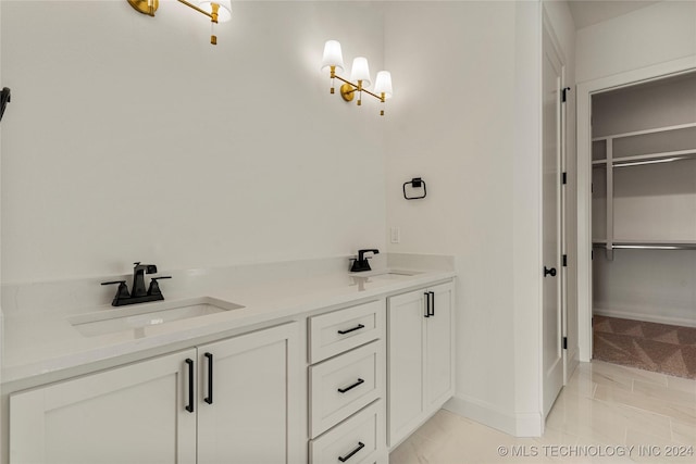 bathroom featuring tile patterned flooring and vanity