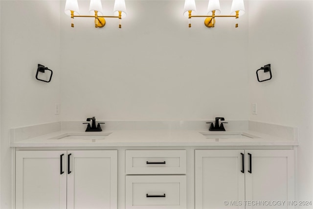 bathroom with a notable chandelier and vanity