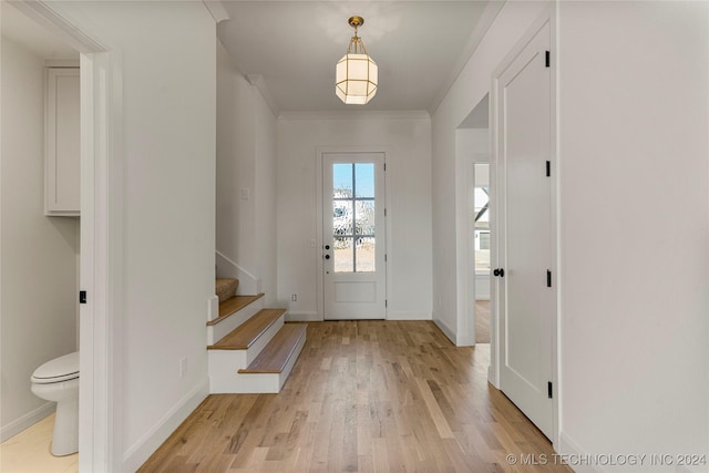 entrance foyer with light wood-type flooring and crown molding