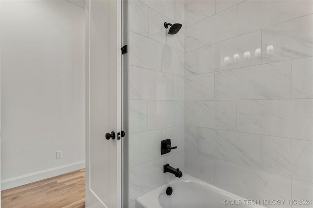 bathroom with wood-type flooring and tiled shower / bath combo