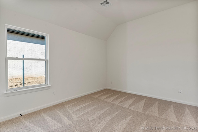 empty room with carpet and lofted ceiling