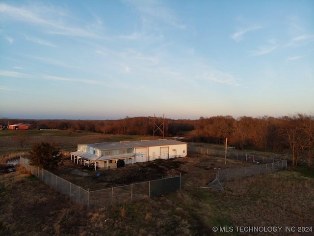 aerial view at dusk featuring a rural view