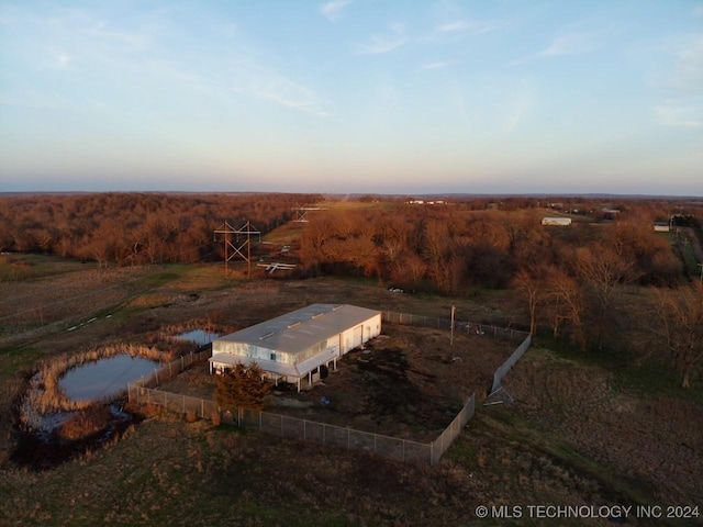 aerial view at dusk featuring a rural view