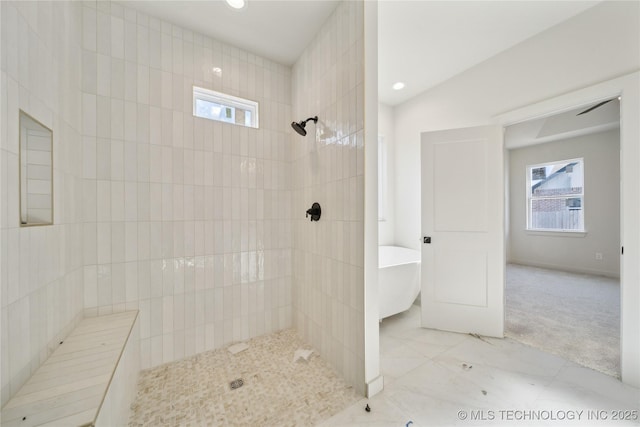 bathroom featuring independent shower and bath