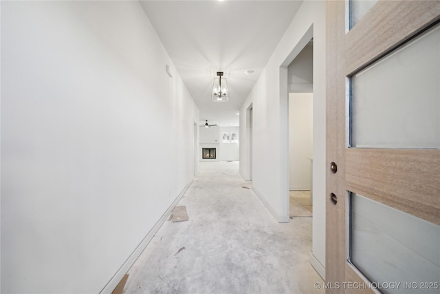 corridor featuring an inviting chandelier