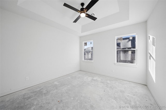 spare room featuring ceiling fan and a tray ceiling