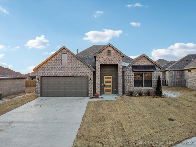 view of front of house with a garage and a front yard