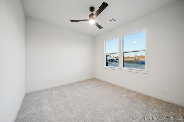 unfurnished room with light colored carpet and ceiling fan