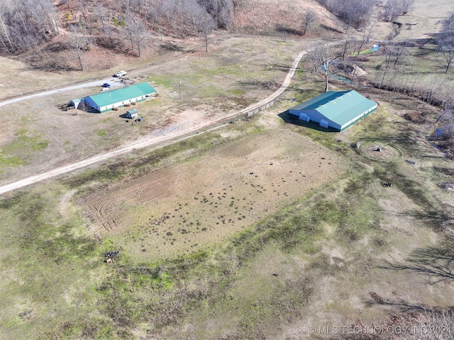 birds eye view of property with a rural view